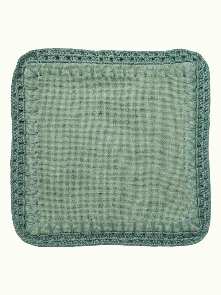 Detail view of Nityam Green Cotton Slub Crochet Coasters Set Of 6 highlighting the fabric texture and embroidery detail