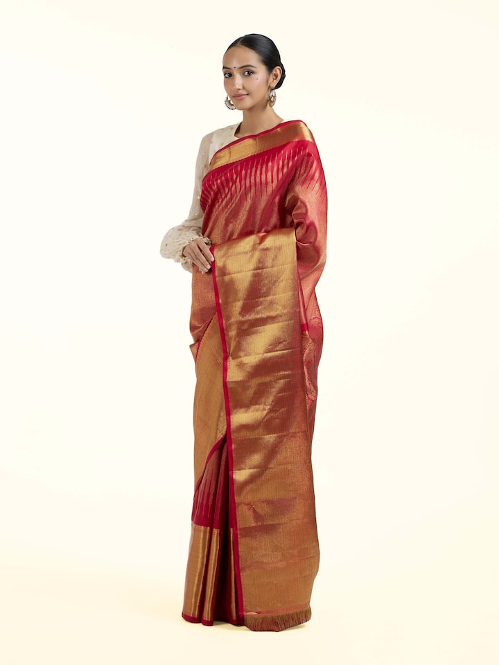 Side view of red silk Kancheepuram saree with graceful drape and contrast border