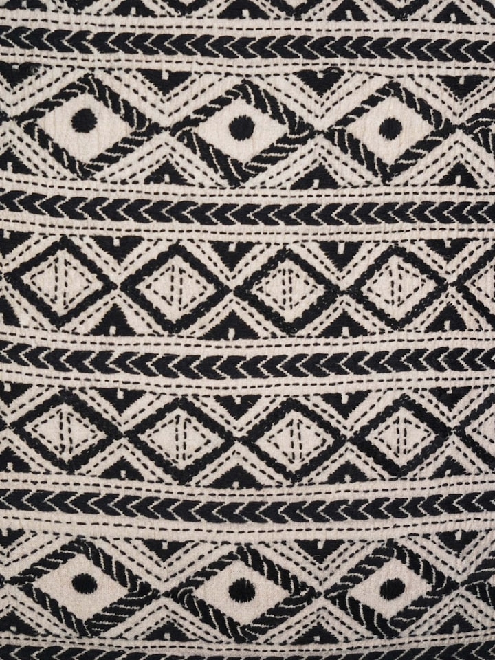 Close-up of Kantha hand embroidery on black cushion cover