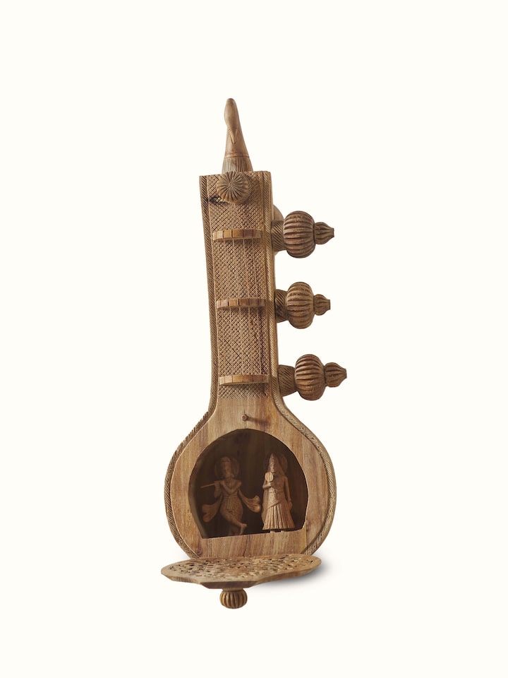 Close-up view of carved sandalwood Vandana Veena sculpture focusing on detailed carvings
