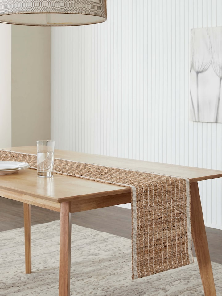 Top-down shot of the table runner laid out fully, highlighting its length and texture on the table
