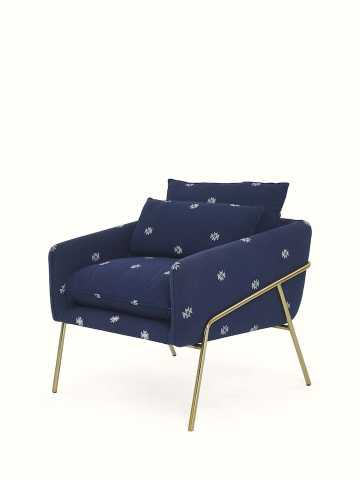 Angled view of Upholstered Metal Armchair emphasizing the ergonomic design and stylish appeal.