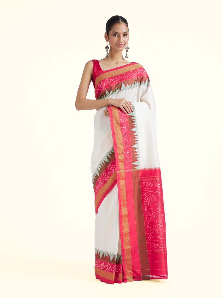 Front view of off-white mulberry silk ikat saree with traditional geometric patterns