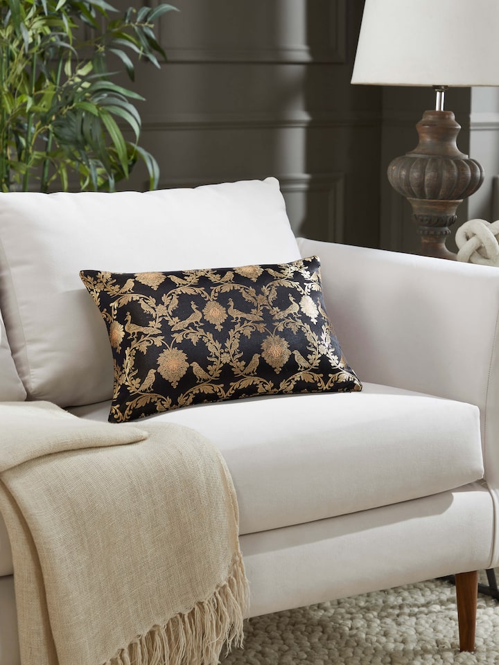 Lifestyle shot of black silk cushion styled with complementing décor, offering regal elegance.