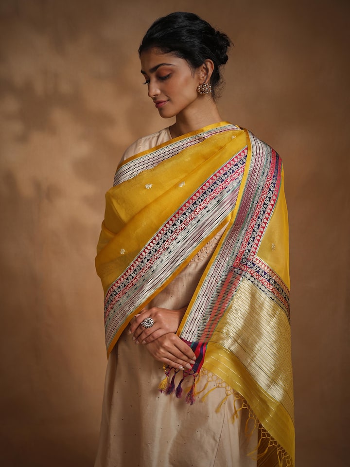 Close-up of traditional motifs on yellow Banarasi silk dupatta