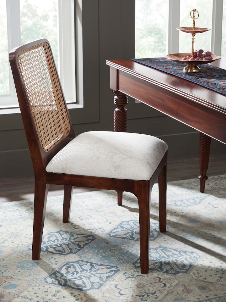 Side view of Sheesham Wood & Cane Dining Chair highlighting the elegant armrests and comfortable design with woven cane accents.