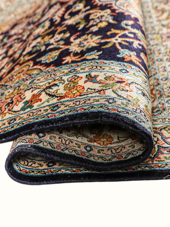 Detailed view of the Traditional Persian Navy Rust Kashan Kashmir Silk Hand-Knotted Carpet craftsmanship