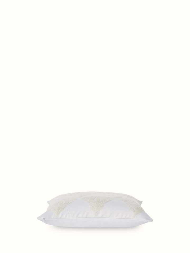 Angled view highlighting detailed hand embroidery and linen texture.