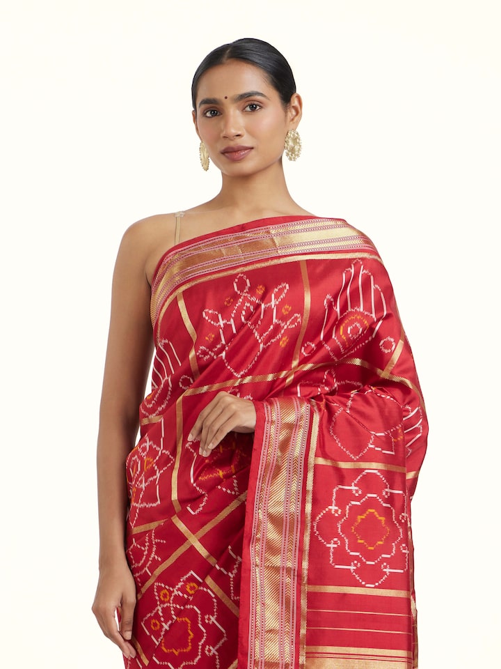 Angled view of Red Pochampally Single Ikat Saree revealing the depth of its color and intricate pattern