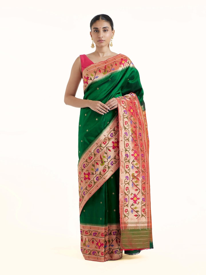 Front view of green silk Paithani saree showcasing traditional woven motifs