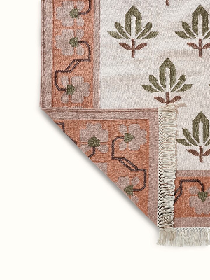 Front view of Contemporary lotus blush lawan cotton panja dhurrie, illustrating its blush color and panja weave texture.