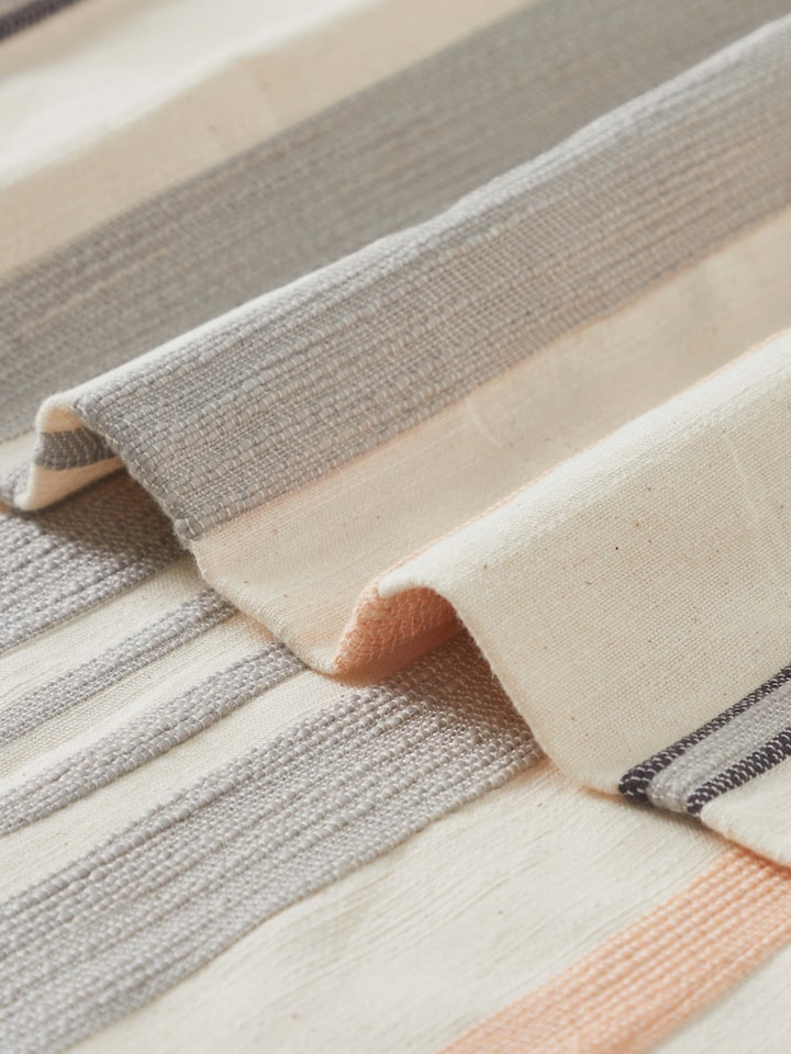 Detail view highlighting the handloom weave and subtle stripe gradation in Neerja grey cotton bedspread