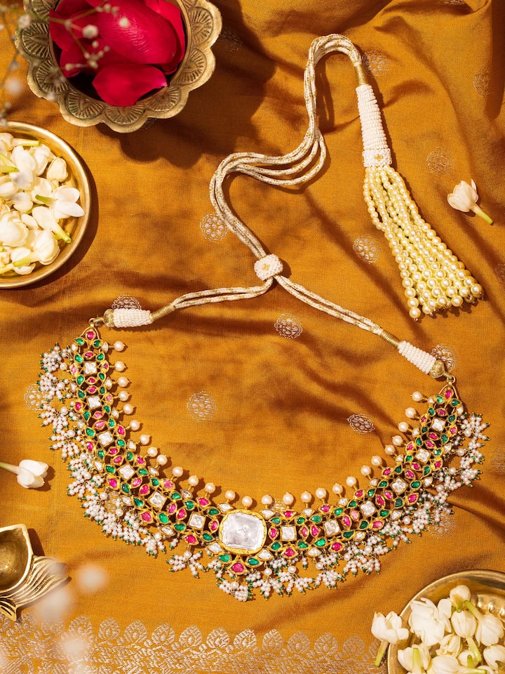 Jadau 18 karat gold collar necklace worn on neck