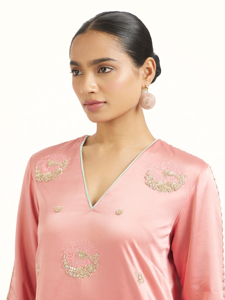 Angled view of orchid pink zardozi kurta set emphasizing detailed zardozi work