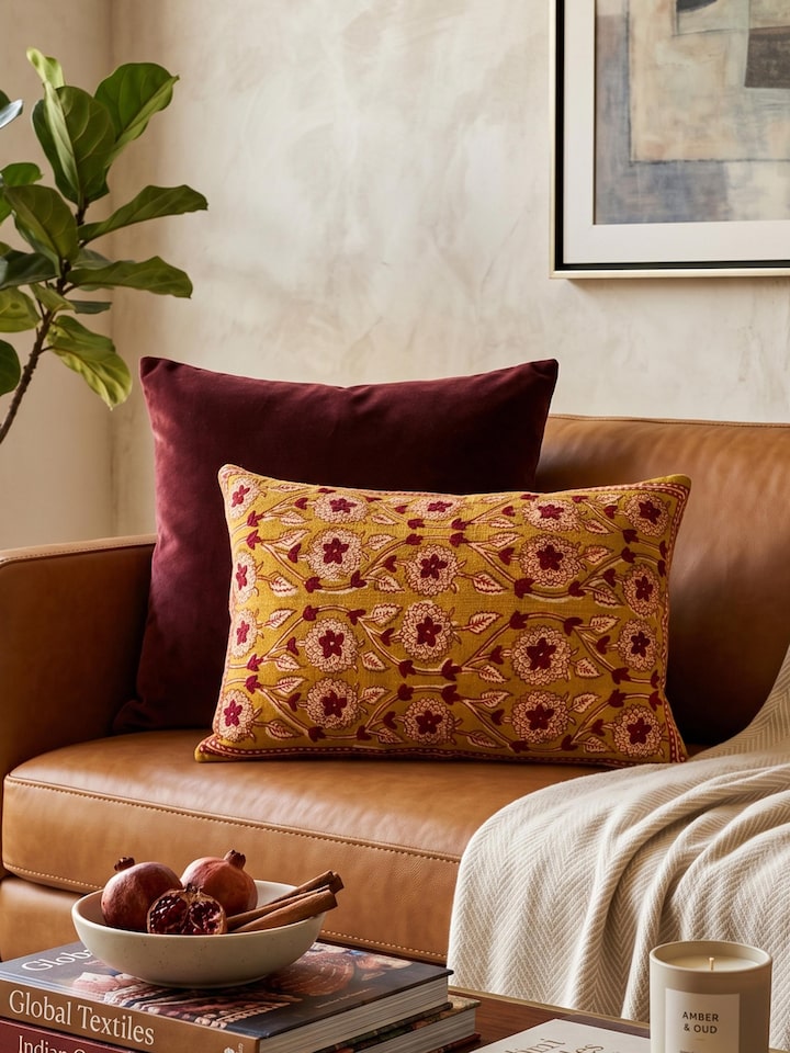 Lifestyle view of the Marigold Hand Block Dabu With Embroidery Floral Cushion