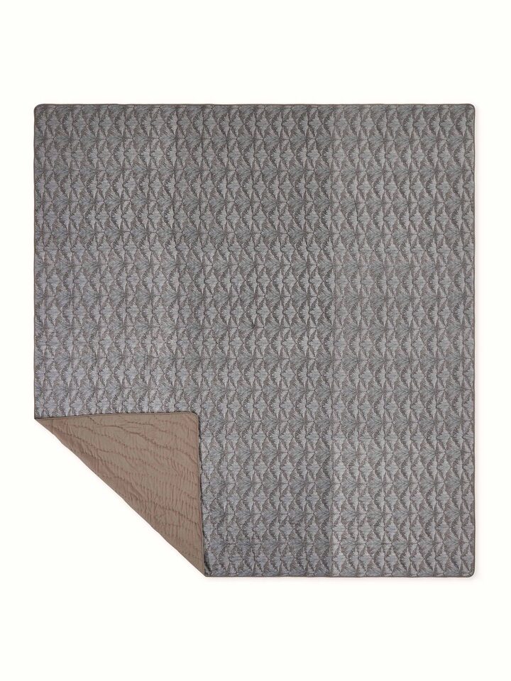 Back view of Parvat brown double quilt displaying plain silk fabric underside.