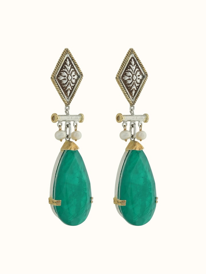 Angled view of silver smithing drop earrings