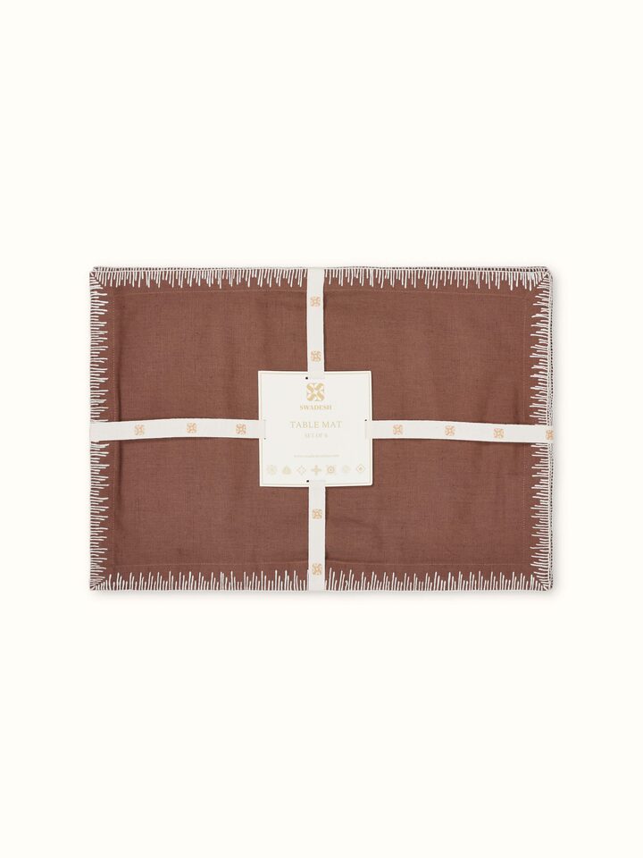 Corner and stitch detail of brown linen cotton embroidered table mat