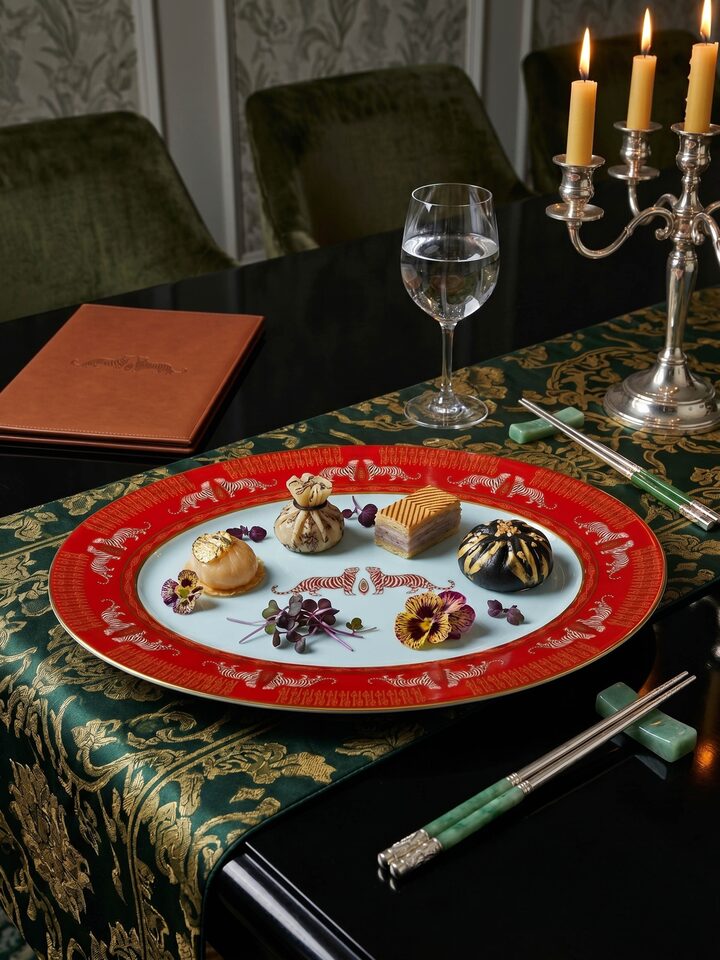 Styled view of Oval Ceramic Serving Platter With Gold-Accented, Glaze-Set Motifs styled in a home setting