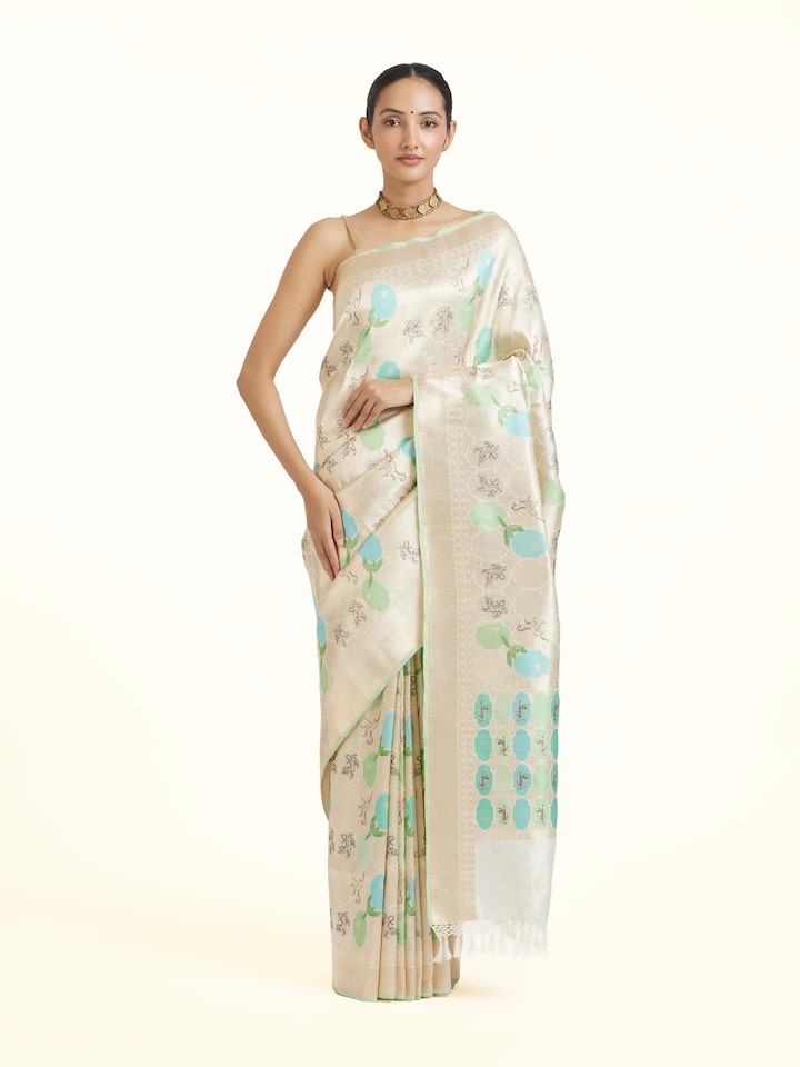 Angled view of the Off-white Silk Brocade Handloom Banarasi Saree