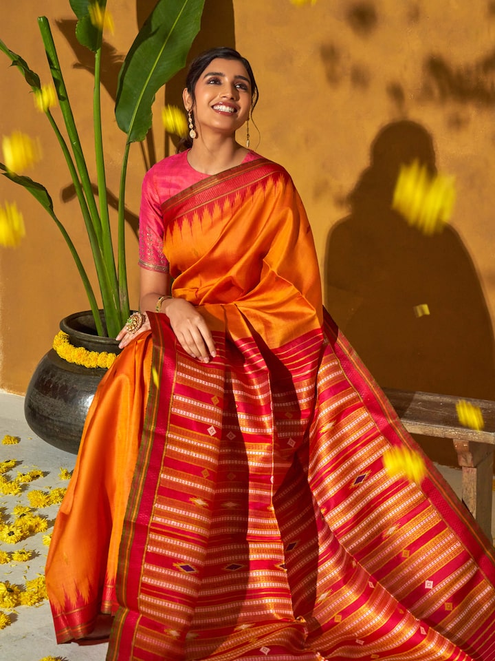 Back view of orange tussar silk bandha Odisha ikat saree displaying the full design and texture