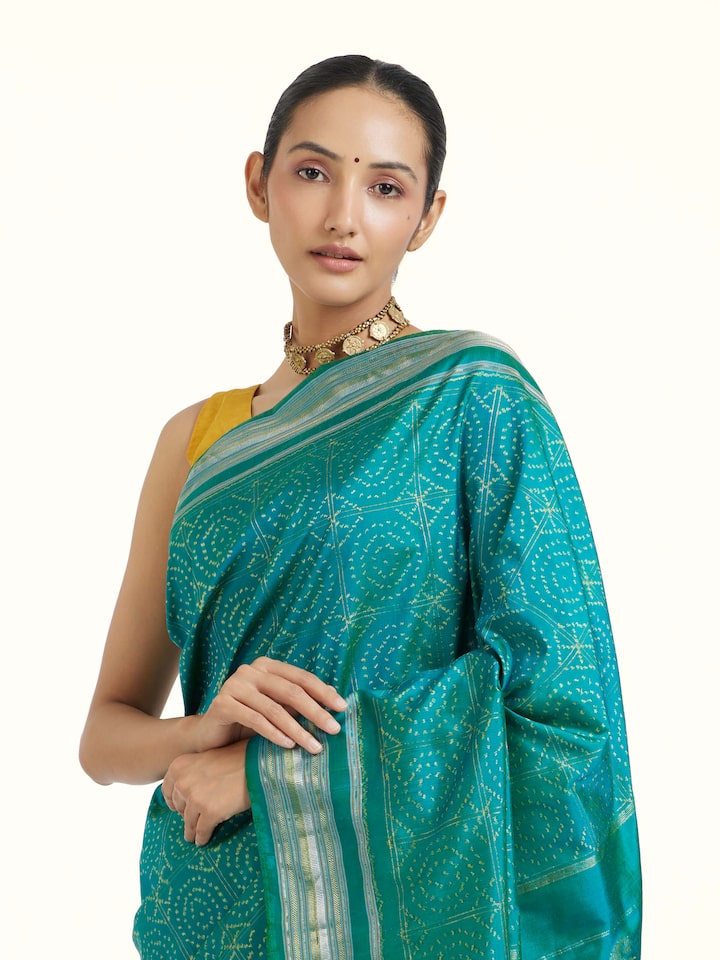 Angled view of Turquoise Pochampally Double Ikat Saree revealing the depth of its color and intricate pattern