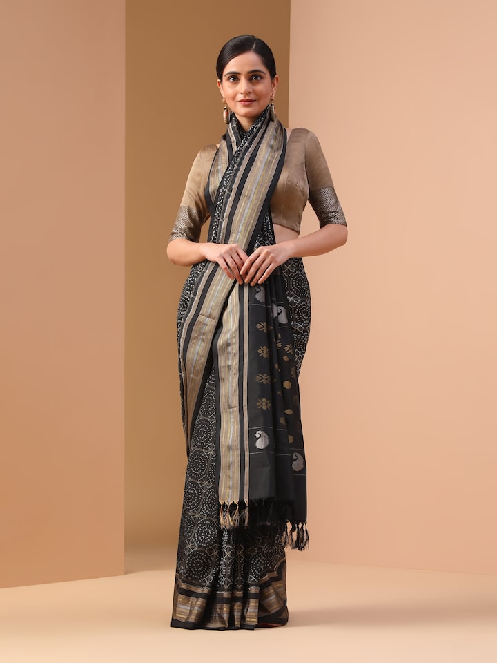 Alternate front view showing full drape of black silk double Ikat saree with bold borders