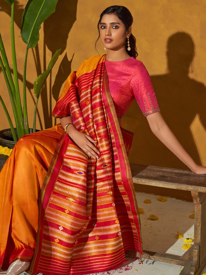 Close-up of orange tussar silk bandha Odisha ikat saree focusing on intricate ikat design