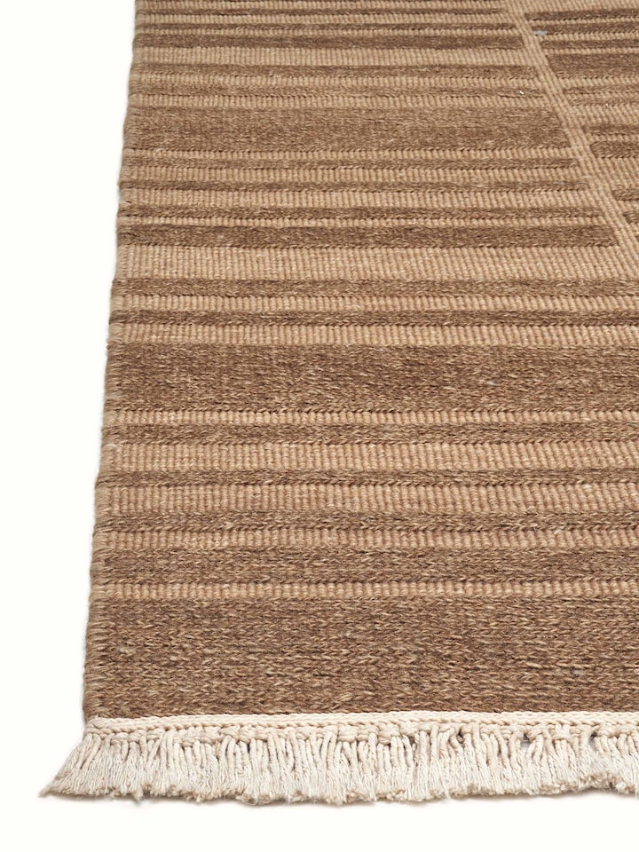 Side angle focusing on the rich texture and depth created by the multi-layered knotting technique