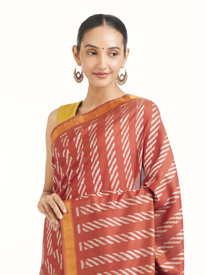 Angled view of pink mulberry silk Patola saree highlighting double ikat weave