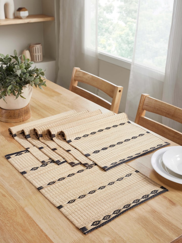 Prakriti Madurkathi black stripe table mats arranged in a rustic dining table setting