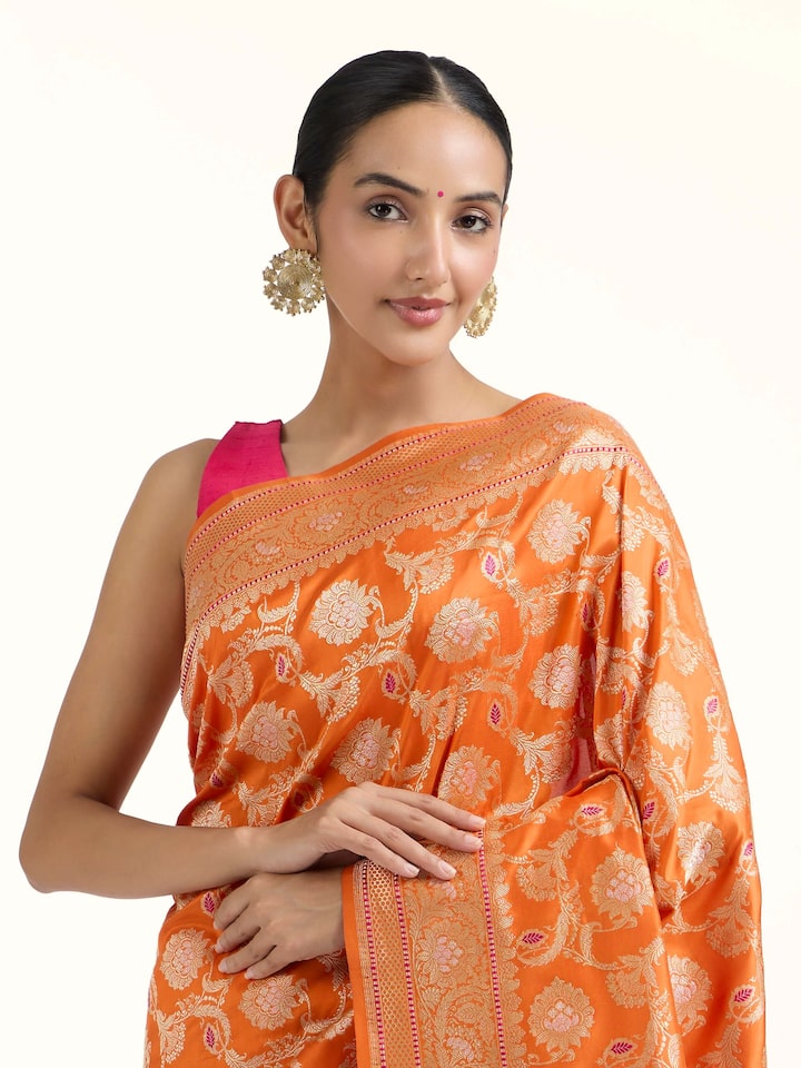 Angled view of Orange Banarasi Kadhwa Silk Saree revealing the depth of its color and intricate pattern