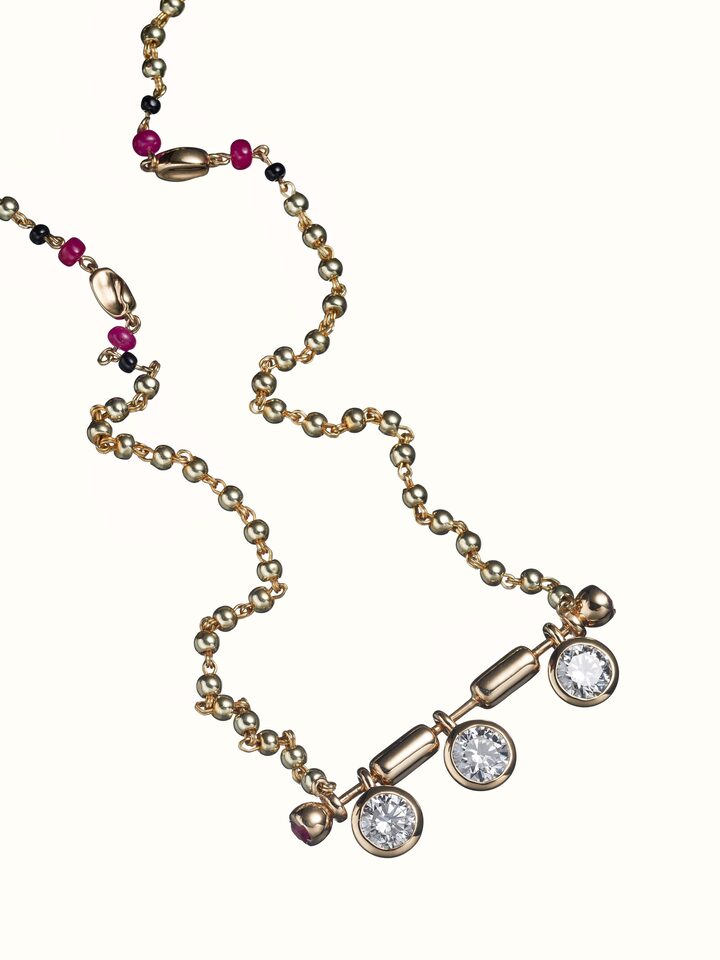 angled view of open setting 14 karat gold mangalsutra