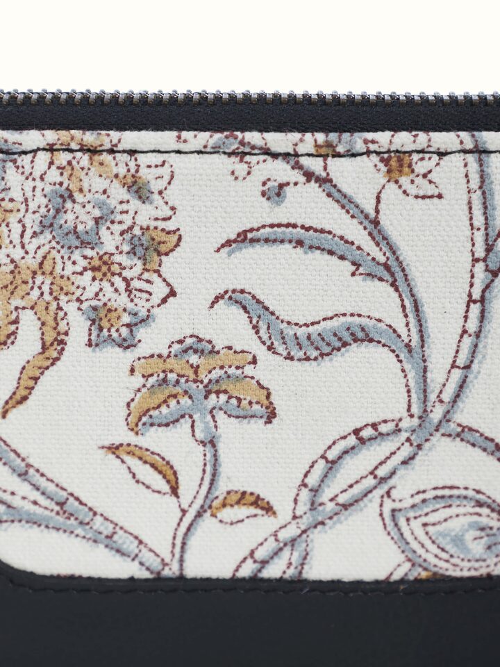 Detailed shot of zipper and stitching on handcrafted travel wallet.