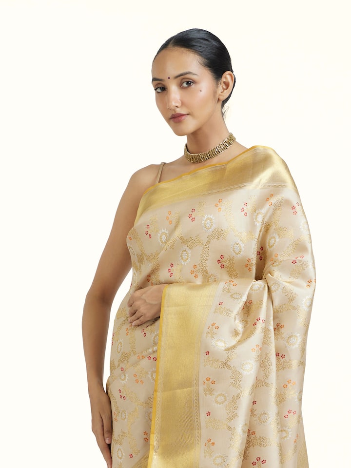 Angled view of Beige Kancheepuram Silk Zari Saree revealing the depth of its color and intricate pattern