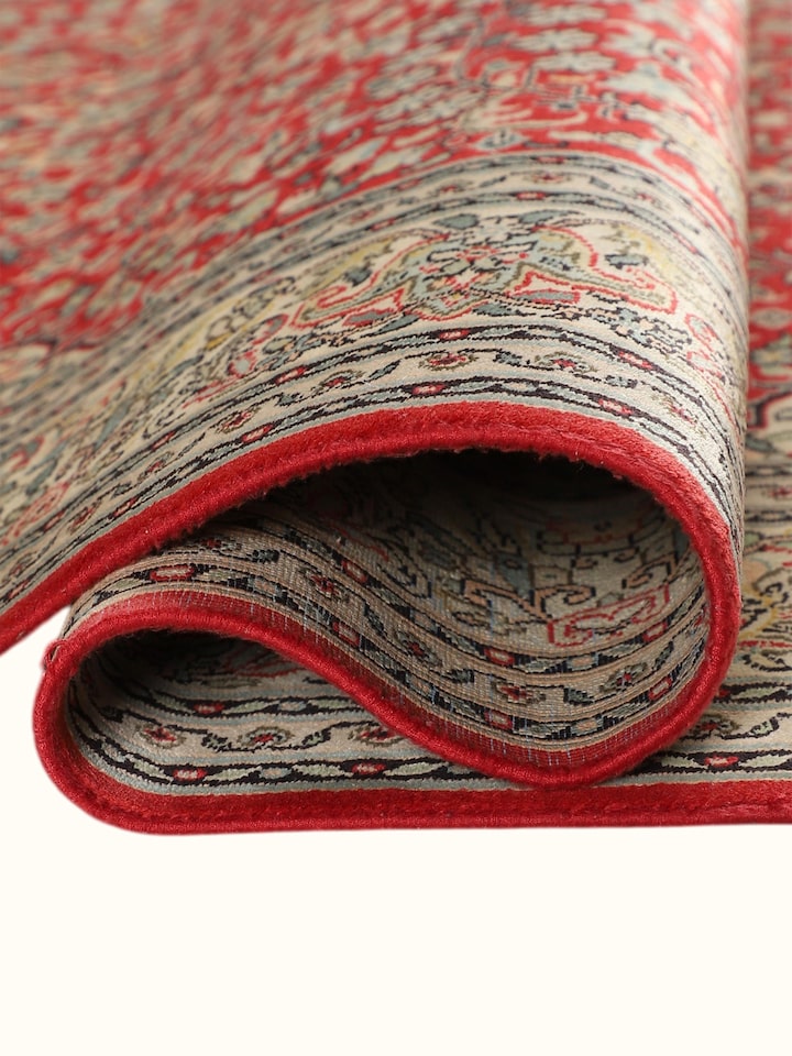 Detailed view of the Traditional Persian Red Ivory Kashan Kashmir Silk Hand-Knotted Carpet craftsmanship