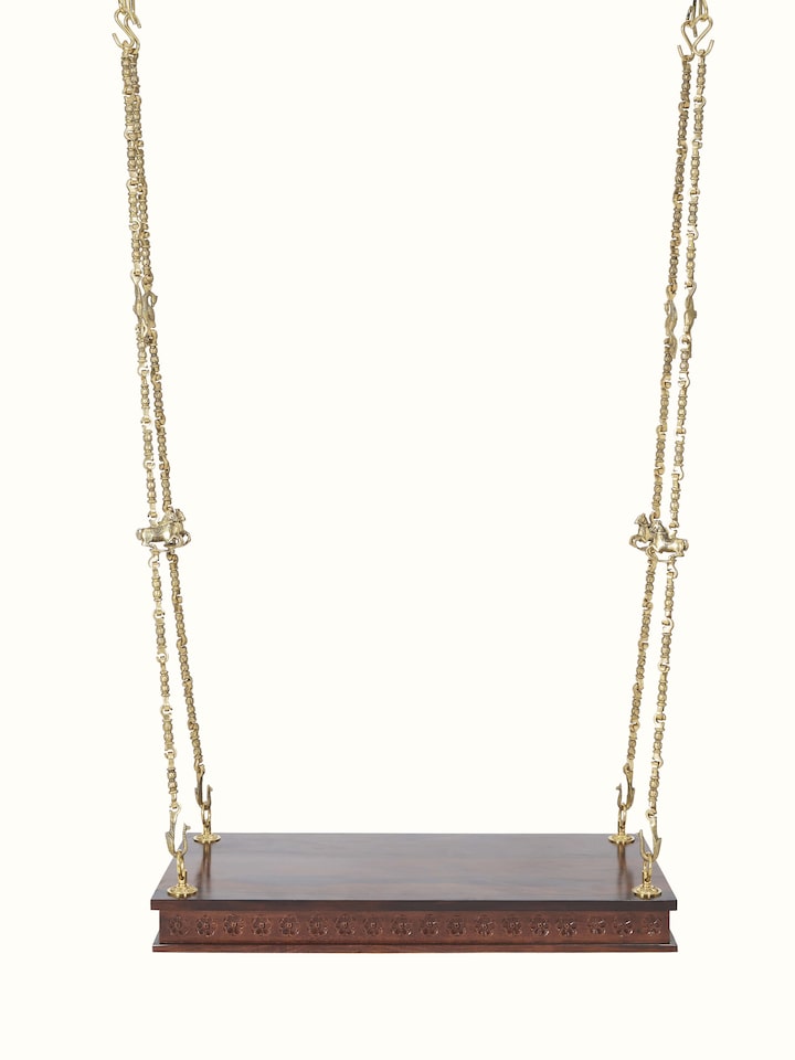 Front view of carved Sheesham wood and brass swing, highlighting its intricate design and elegant craftsmanship.