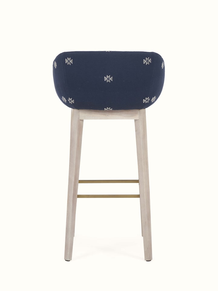 Close-up view showcasing the fine details of the upholstered acacia wood bar chair.