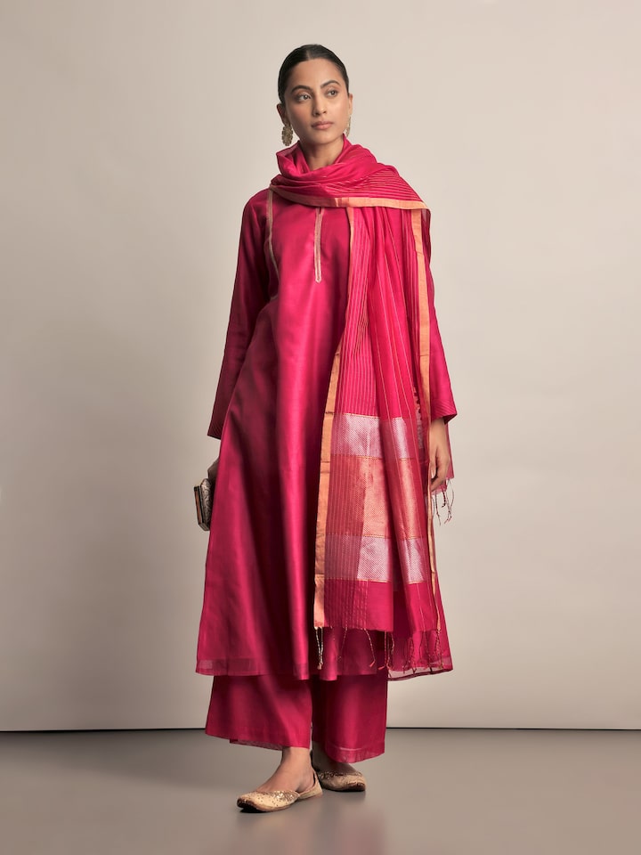 Angled view of fuschia Chanderi palazzo showing pleated design and lightweight fabric