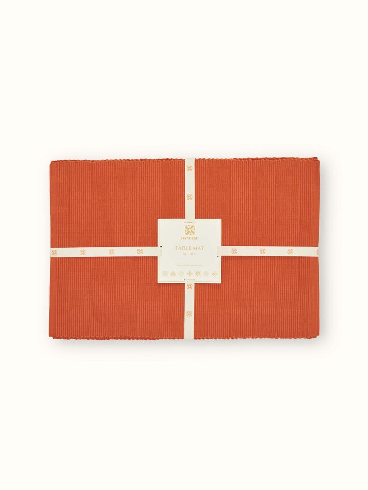 Close-up highlighting the fine handloom weave and rich rust hue