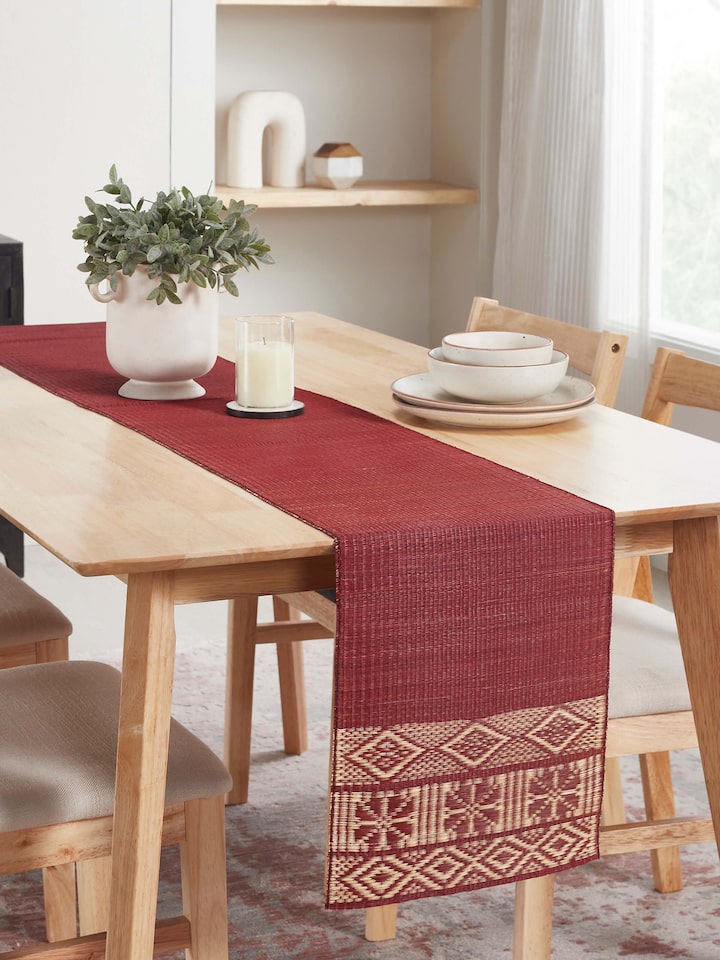 Styled view of Prakriti Red Folk Geo Natural Fibre Madurkathi Table Runner (6 Seater) styled on a table or bed setting