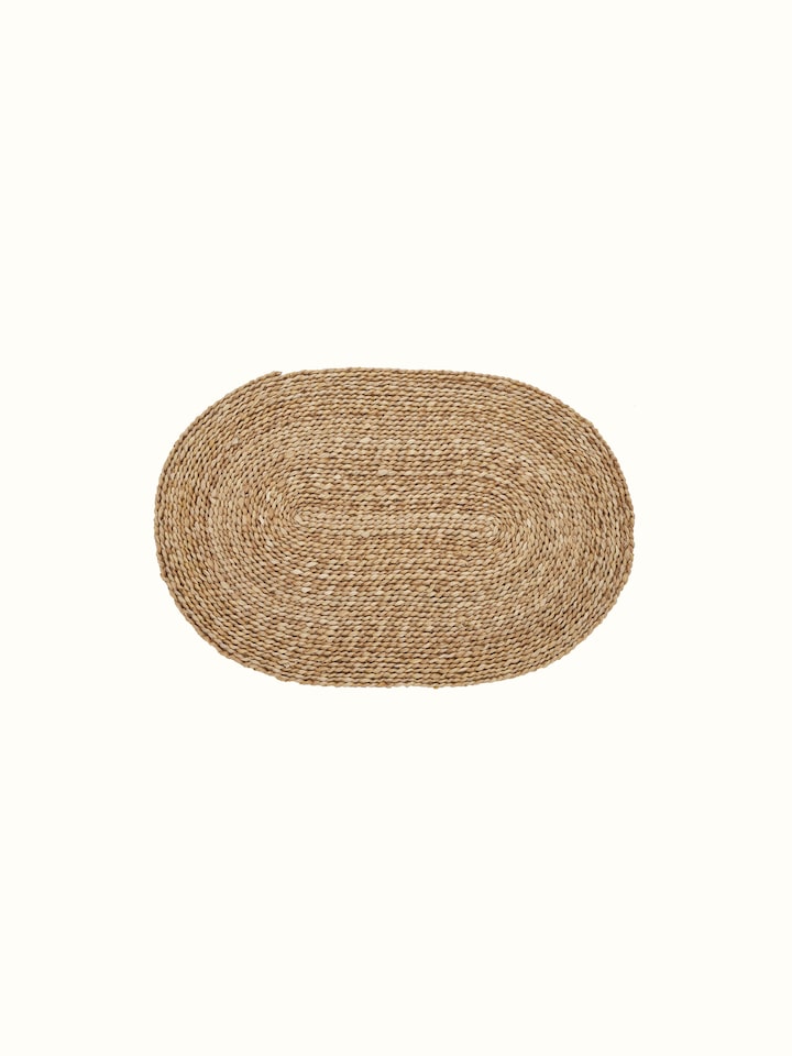 Vritti brown solid oval natural fibre trivets displayed to show their full design and texture.