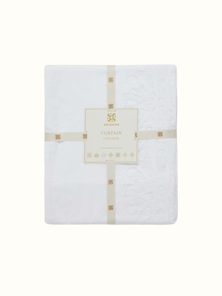 Detailed zoom of curtain fabric and craftsmanship of white jaal appliqué design