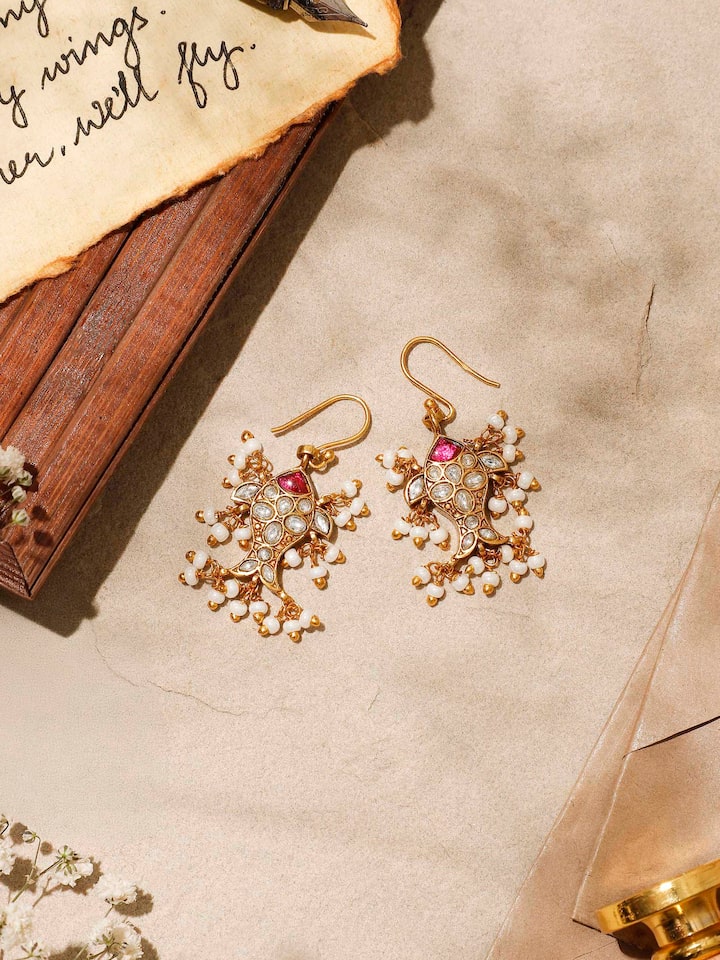 Side view emphasizing the earrings’ graceful curve and polished surface