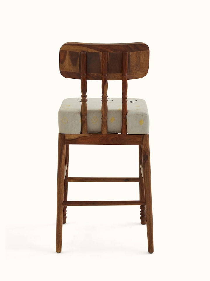 Angled view of Upholstered Sheesham Wood Bawan Buti Bar Stool with focus on wood and upholstery details