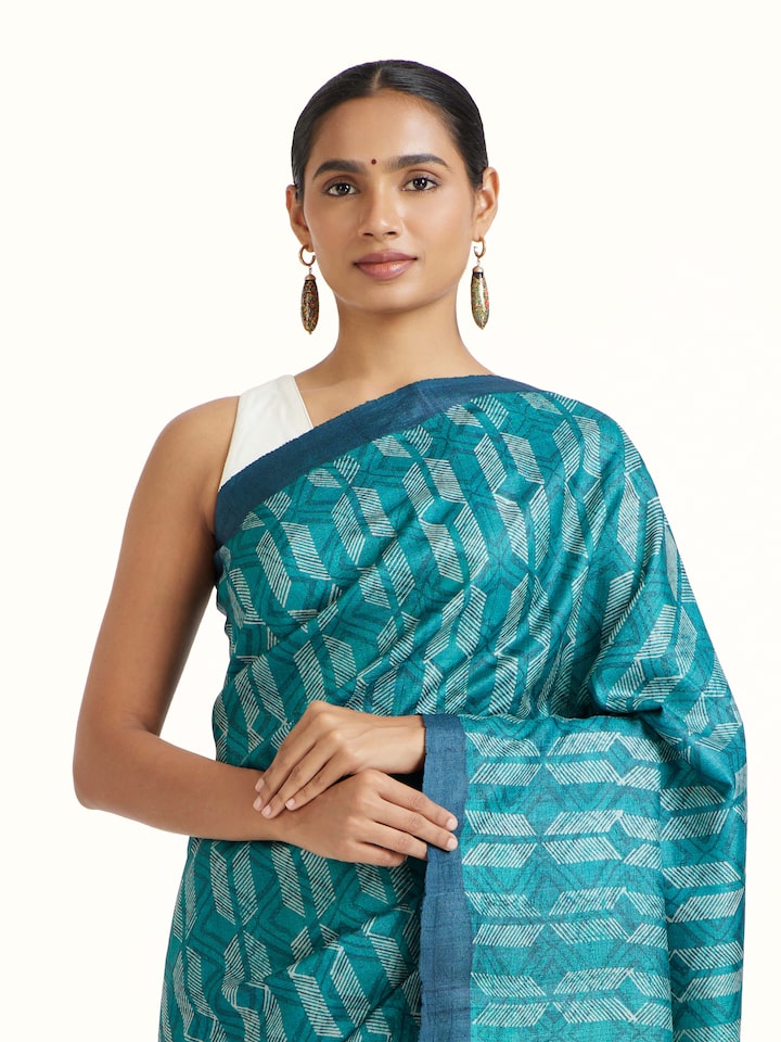 Angled view of Sea Green Tussar Silk Discharge Block Printed Saree revealing the depth of its color and intricate pattern