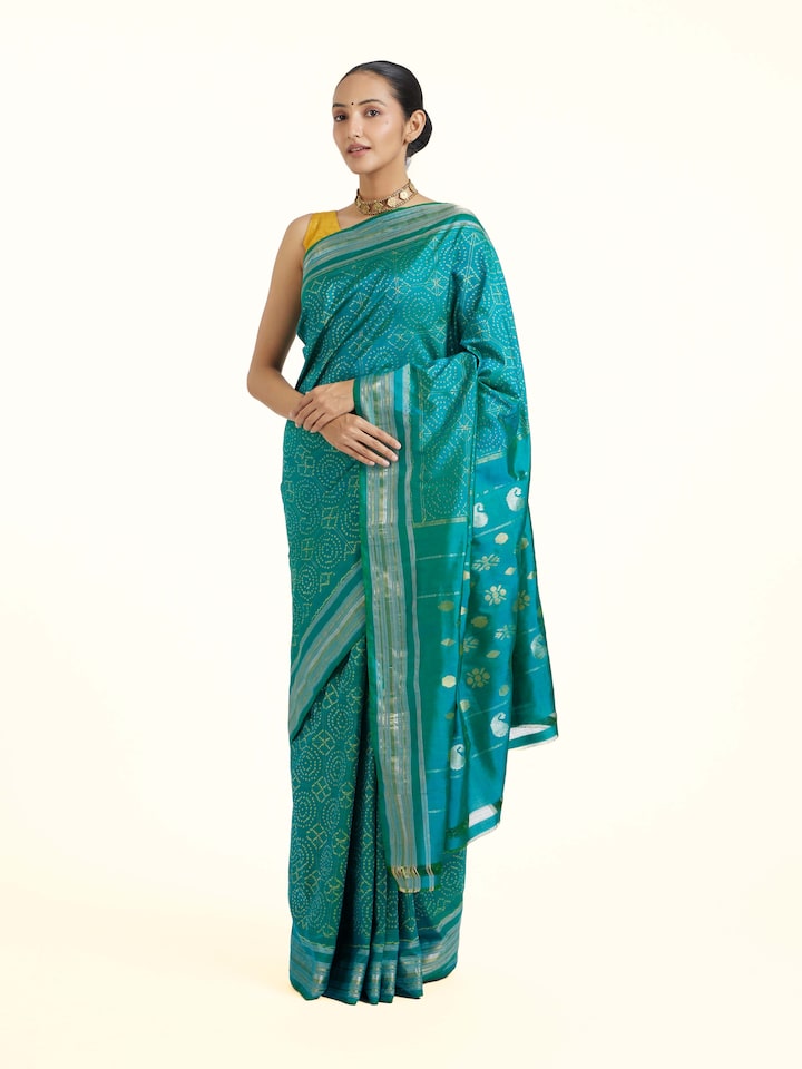 Side view of Turquoise Pochampally Double Ikat Saree highlighting the detailed craftsmanship and elegant silhouette