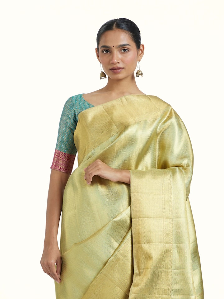 Angled view of Green Kancheepuram Silk Zari Saree revealing the depth of its color and intricate pattern