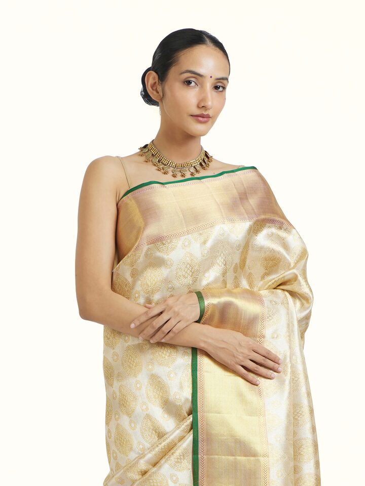 Angled view of Gold Kancheepuram Silk Zari Saree revealing the depth of its color and intricate pattern