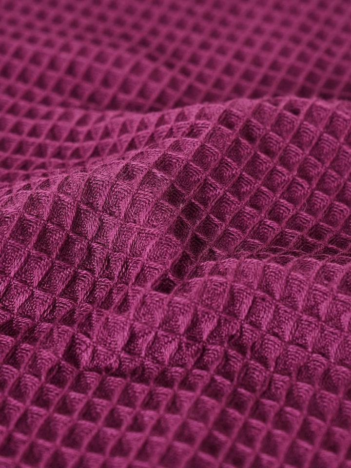 Close-up of waffle weave texture on purple cotton hand towel
